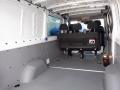 Interior of a 2016 Mercedes-Benz Sprinter showing seating for three passengers and a spacious cargo area with a gray floor and minimal features