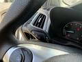 Close-up of the steering wheel and control stalk of a 2021 Ford Transit Connect featuring dashboard gauges and ventilation controls