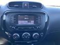 Dashboard of a 2017 Kia Soul featuring a digital radio display control panel with buttons for adjusting volume and climate settings