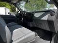 Interior of a 2016 Ford F-550 featuring gray leather seats and a modern dashboard design with a Super Duty label