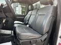 Interior of a 2016 Ford F-550 with two black leather front seats visible and a steering wheel in the foreground