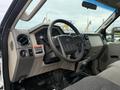 Interior view of a 2008 Ford F-550 truck showing the steering wheel dashboard gearshift and seating area