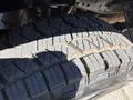 Close-up of a rugged tire with deep treads designed for off-road traction mounted on a 2014 Ford F-250 SD