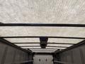 Interior view of a 2012 Ford Econoline cargo van showing the ceiling with support beams and a light fixture