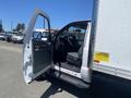 A 2015 Ford F-450 Super Duty with an open driver's door revealing the interior and dashboard of the truck