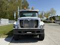 A front view of a 2009 International 7500 truck with a chrome grille and orange lights on top