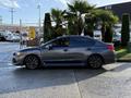 A gray 2021 Subaru WRX parked with a sleek design featuring a sporty stance and tinted windows