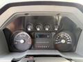 The dashboard of a 2011 Ford F-350 SD showing various gauges for speed fuel levels and engine performance