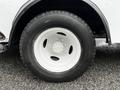 Close-up of a white wheel with a black tire on a 2013 Ford Econoline