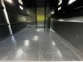 Interior view of a 2012 Freightliner M2 106 showing a spacious empty cargo area with a smooth black floor and vertical walls