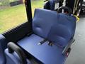 A blue fabric seat with two armrests and a seatbelt designed for a passenger in a vehicle