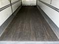 The interior of a 2019 International 4300 truck featuring a wooden floor and metal side rails