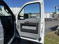 A 2016 Ford F-550 with the driver's side door open showing the interior door panel and gray handle