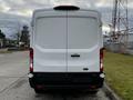 A white 2020 Ford Transit van viewed from the rear with a sleek design and no visible markings