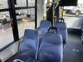 Interior view of a 2018 Chevrolet Express showing blue upholstered passenger seats and a safety strap on the side