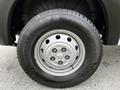 A close-up of the wheel of a 2021 RAM Promaster featuring a silver steel rim and a black tire with tread patterns