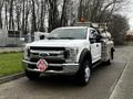 A 2018 Ford F-550 truck with a silver and black exterior equipped with a fuel tank in the bed and safety markings on the side