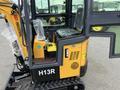 A 2024 AGT Industrial Yellow H13R Mini Excavator showing the operator's cabin with a clear view of the seat control panel and joystick