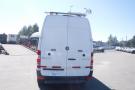 A 2012 Mercedes-Benz Sprinter van with a white exterior and rear-view perspective featuring a roof-mounted equipment rack