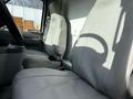 Interior of a 2013 Ford Econoline showing two gray cloth front seats with armrests and seat belts