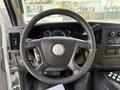 The steering wheel of a 2017 Chevrolet Express with control buttons and a logo in the center of the wheel