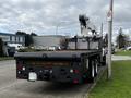 A 2008 International 7500 truck with a flatbed and mounted crane positioned on the rear