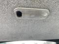 A light fixture with a textured cover mounted on a ceiling panel