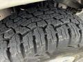 Close-up of a rugged tire tread from a 2004 Ford Econoline showing deep grooves and a thick rubber surface designed for traction