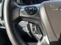 Close-up of the steering wheel and controls in a 2017 Ford Transit with buttons for navigation and audio settings
