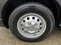 A close-up of a silver wheel with six bolts and a Continental tire featuring a tread pattern suitable for various driving conditions