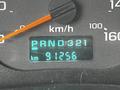 Image shows the dashboard display of a 2006 GMC C5000 with a digital odometer reading 91256 km and gear indicators for park reverse neutral drive and gears 3 2 1