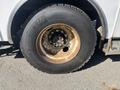 A close-up view of a rusty tire mounted on a wheel of a 2007 International 7300 truck showcasing the tire tread and wheel rim details