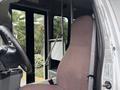 The image features the interior of a 2014 Ford E-350 showcasing the driver's seat and controls with seatbelt visible