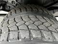 Close-up view of a heavily treaded tire from a 2011 Ford F-550 showcasing the rugged pattern designed for traction and durability