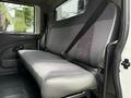 Interior view of a 2012 International TerraStar featuring a single gray bench seat with seatbelt in a commercial vehicle setup