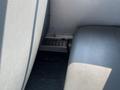 A view of the interior of a 2007 Blue Bird Vision bus showing a gap between two seats and a metal vent below