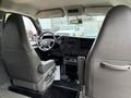 Interior view of a 2021 Chevrolet Express showing the driver's seat and dashboard with controls and displays