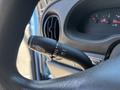 A close-up of the control stalk on the steering column of a 2008 Ford E-350 showing functions for windshield wipers and indicators