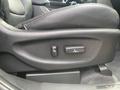 Close-up of the seat adjustment controls in a 2015 Kia Sorento featuring buttons for seat height and lumbar support