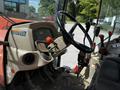The interior of a 2011 Kubota M8540D tractor showing the steering wheel dashboard and control levers