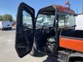 A 2018 Kubota ATV with an open door showcasing the interior features and dashboard, including controls and seating