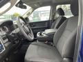 Interior view of a 2019 RAM 1500 Classic showing the driver's seat, steering wheel, and center console with a textured fabric pattern on the seats