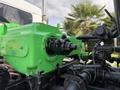 A bright green engine component of a 1996 Kenworth T800 with various hoses and mechanical parts visible in the foreground