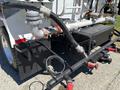 A close-up view of a 2008 International DuraStar's rear connections featuring various pipes hoses and valves attached to the chassis