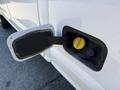 Close-up of a fuel door on a white 2017 Ford F-350 SD with the cap removed revealing the fuel tank opening