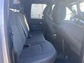 Interior view of a 2021 RAM 1500 showing the front passenger seat and dashboard area with black fabric seating