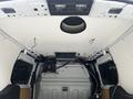 Interior view of a 2016 Ford Transit Connect cargo van with exposed ceiling and wiring along the side walls