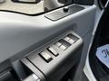 Window control panel of a 2016 Ford F-550 featuring four buttons for adjusting windows