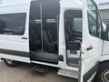 2009 Dodge Sprinter Van with an open side door showing multiple seats in the interior and a step for easy access