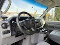 Interior view of a 2023 Ford E-450 with a steering wheel dashboard controls and a center console